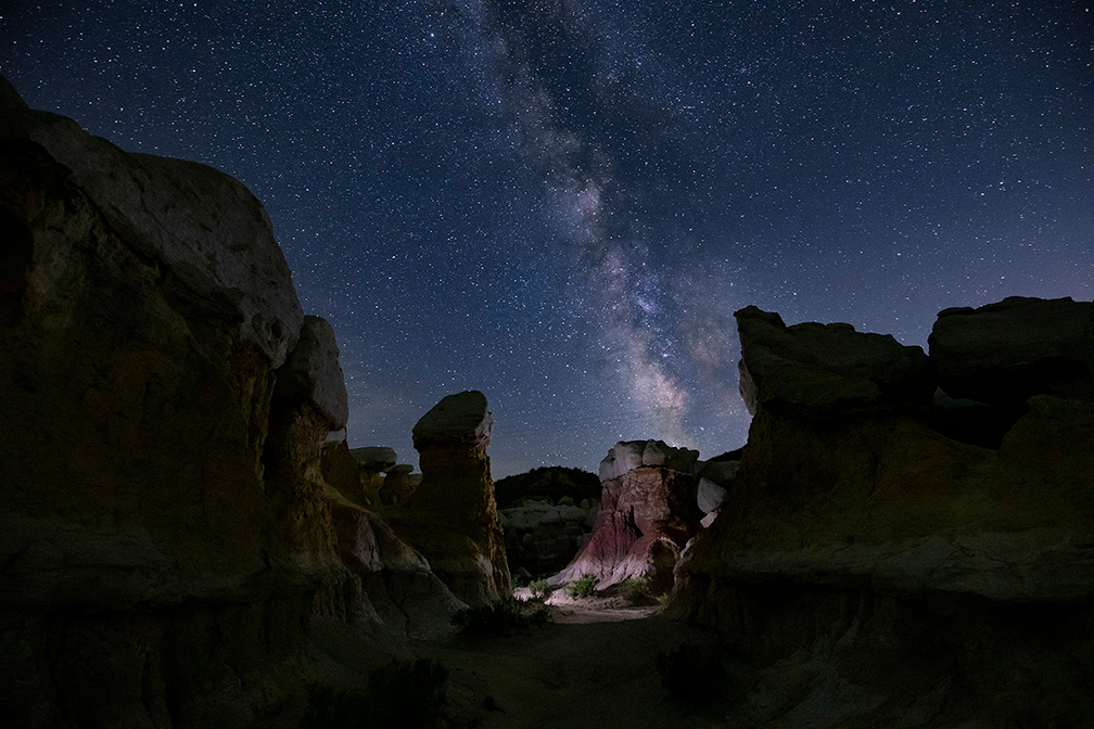 Paint Mines Milkyway with lit up rock formation nighttime photography workshop